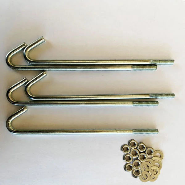 Three metal anchor bolts with threaded ends are placed horizontally above a cluster of nuts and washers on a plain white surface.