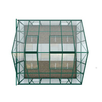 A green-framed glass Rhino Greenhouse, viewed from above, shows two open roof vents, revealing a gravel base inside. The structure is set against a plain white background.