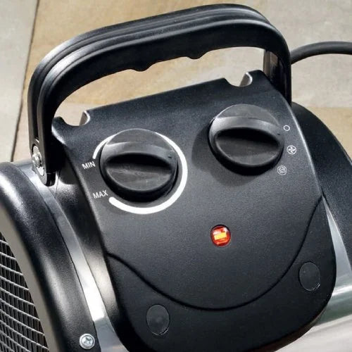 The object is a black electric heater with two dials. One dial ranges from MIN to MAX for temperature control. It's in an indoor environment with a handle on top.