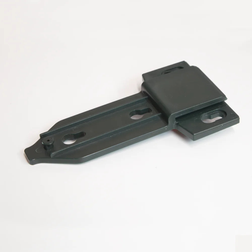 A dark green metal bracket lies on a white surface. The bracket features multiple mounting holes and an angled design, suitable for securing components or structures in place.