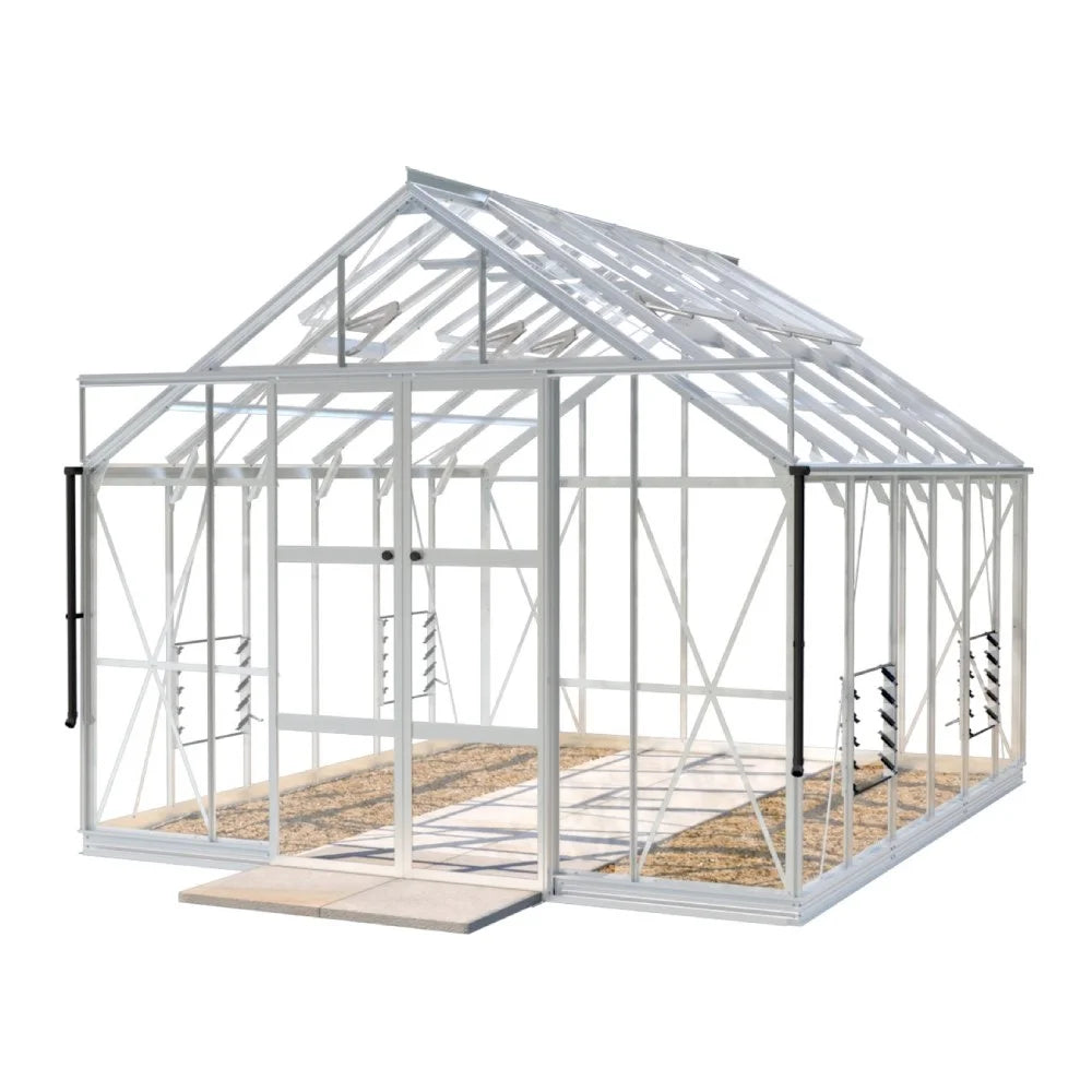 A white, metal-framed Rhino Greenhouse with clear panels and open double doors stands on a concrete base. The interior shows orderly soil paths, and it appears to be in an outdoor setting.