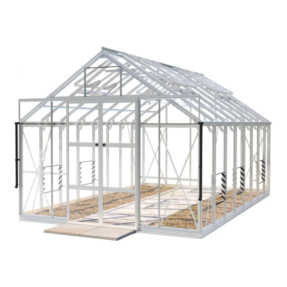 A large, white-framed Rhino Greenhouse with transparent panels stands on a stone-tiled base. It features roof vents and side louvre windows, providing space for plant cultivation in a garden setting.
