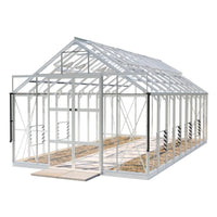 Glass Rhino Greenhouse with a white metal frame, featuring double doors open wide. Set on a tiled pathway, it is designed to allow maximum light inside.