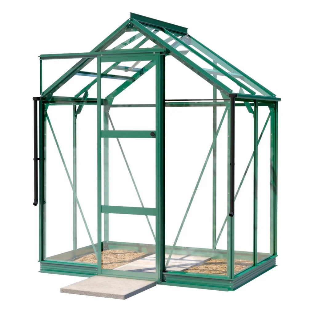 A small, green-framed glass Rhino Greenhouse stands on a concrete slab, featuring a rectangular door and transparent panels, suitable for gardening in a controlled environment.